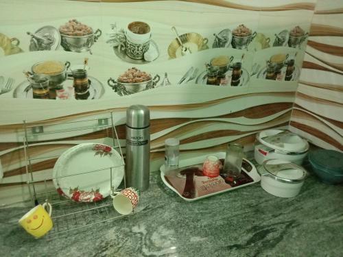 a kitchen counter with a sink and a plate of food at Thendralhomestay in Puducherry