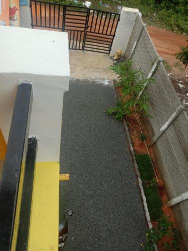 a view of a patio with water on the ground at Thendralhomestay in Puducherry