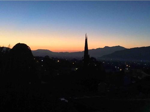 a silhouette of a church with the sunset in the background at Casa Marú in Oaxaca City