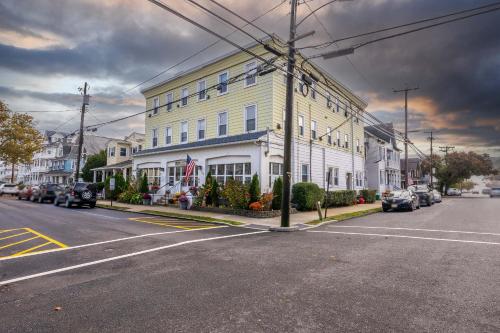 a large white building on a street with cars parked in front of it at The Allenhurst in Ocean Grove