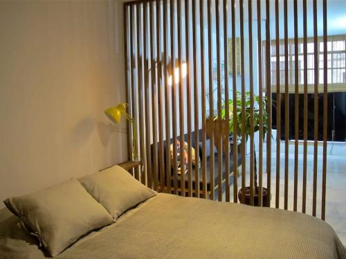 a bedroom with a bed and a large window at Casa da Travessa in Lisbon