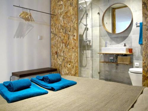 a bedroom with a bed with blue pillows and a sink at Casa da Travessa in Lisbon