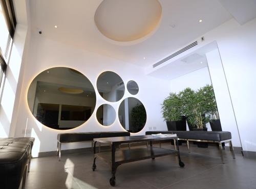 a living room with a table and a couch at Pelican London Hotel and Residence in London