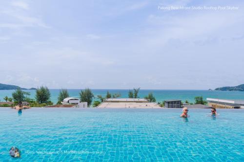 a group of people in the water in a swimming pool at ✪✪✪✪✪ Patong Beachfront Studio Rooftop Pool Skybar in Patong Beach