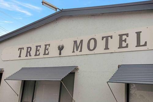 a tree motel sign on the side of a building at The Tree Motel in Narooma