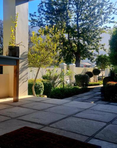 a stone walkway in front of a building at Bergview Guesthouse Swellendam in Swellendam
