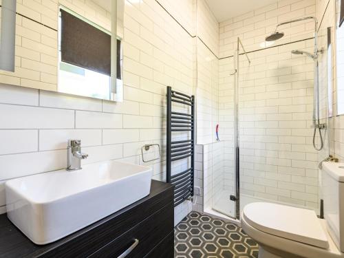 a white bathroom with a sink and a toilet at Low Bank in Lancaster