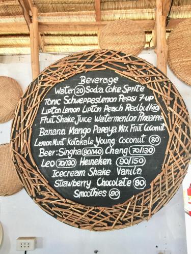 a sign that is on a wall with a basket at Lamai chalet in Amphoe Koh Samui