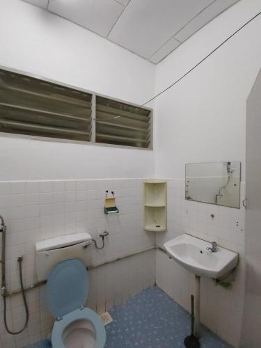 a bathroom with a toilet and a sink at GP Hostel Penang in George Town