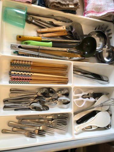 a refrigerator drawer filled with lots of utensils at 一軒家貸切いすみベース in Chōjamachi