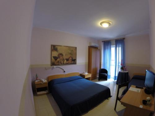 a hotel room with a bed and a desk and a computer at Flying Hotel in San Maurizio Canavese