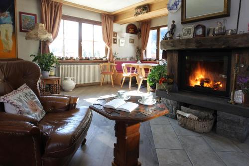 a living room with a couch and a fireplace at Alpi & Golf Hotel in Bormio