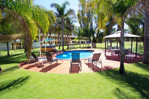 a backyard with a pool and chairs and a gazebo at Tocumwal Golf Resort in Tocumwal