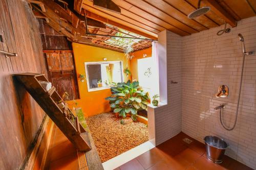 a bathroom with a shower and a plant in it at Swasthi Serviced Villa in Kanjirapalli