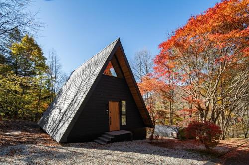 a small black house with a pointed roof at A-Frame House Minami Karuizawa - Vacation STAY 58046v in Karuizawa