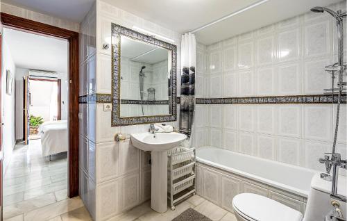 a bathroom with a sink and a tub and a toilet at 6 Bedroom Beautiful Home In La Herradura in La Herradura