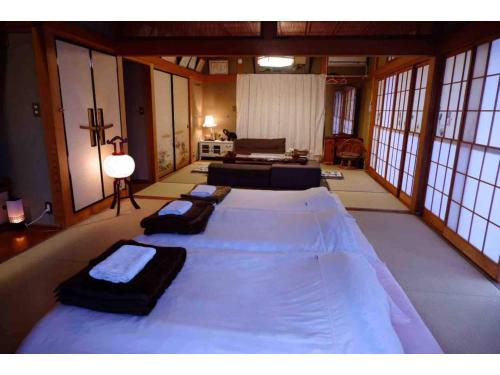 a large room with three beds in the middle of it at Kumamoto Farm Stay - Vacation STAY 12032v in Takemiya