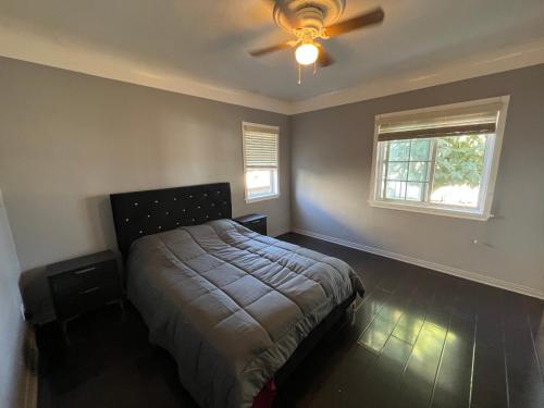 a bedroom with a bed and a ceiling fan at Lucky House in Long Beach