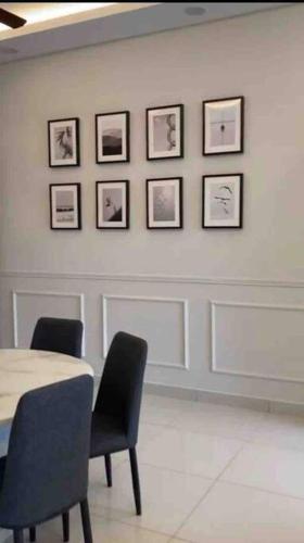 a room with a table and two chairs and pictures on the wall at Millerz Suite 3R2B Condo Near MidValley 3 Beds 3 Bedrooms Staycation Best Choice in Kuala Lumpur