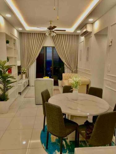 a dining room with a table and chairs and a couch at Millerz Suite 3R2B Condo Near MidValley 3 Beds 3 Bedrooms Staycation Best Choice in Kuala Lumpur