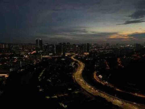 a view of a city at night with cars at Millerz Suite 3R2B Condo Near MidValley 3 Beds 3 Bedrooms Staycation Best Choice in Kuala Lumpur