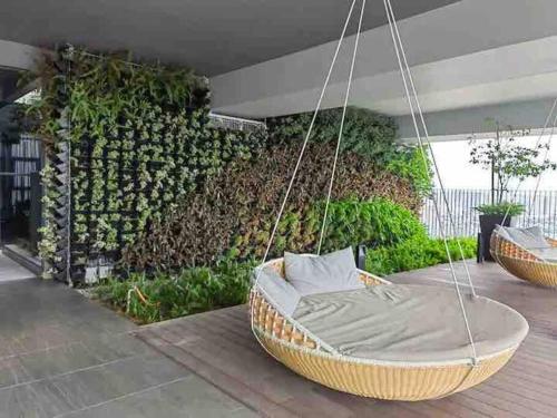 a hammock swing hanging from a patio with a wall at Millerz Suite 3R2B Condo Near MidValley 3 Beds 3 Bedrooms Staycation Best Choice in Kuala Lumpur