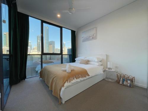1 dormitorio con 1 cama grande y ventana grande en Lovely 2 Beds Apt with City View at South Brisbane, en Brisbane