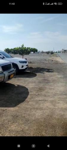 a white truck parked in a parking lot at Beyout Guest Houses in Ma‘mad