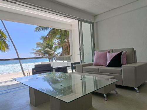 a living room with a view of the ocean at Josan Villa with a Glorious Beach and Sea View in Habaraduwa