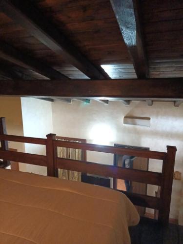 a bedroom with a bed and a wooden ceiling at VILLA ANNA in Casale la Cogna