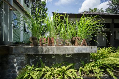 a sign for a garden in front of a house at Tegal Sari Accommodation Ubud in Ubud