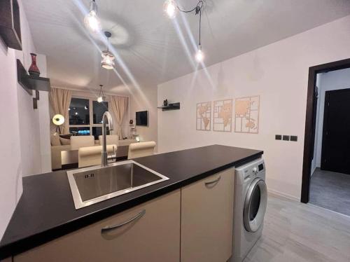 a kitchen with a sink and a washing machine at The Tower - Lovely apartment @ Bansko Royal Towers in Bansko