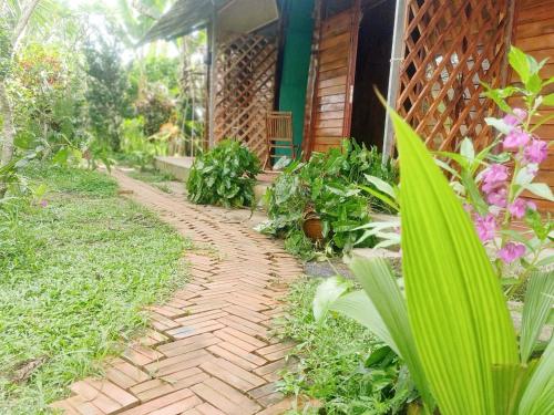 a brick path in front of a house at Happy Farm Tien Giang Homestay in My Tho