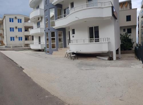 a row of apartment buildings with a bench in front of them at Villa Alba Apartments in Dobra Voda
