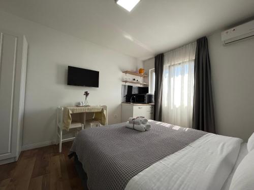 a bedroom with a bed with a teddy bear on it at Central Studio Apartments in Tirana