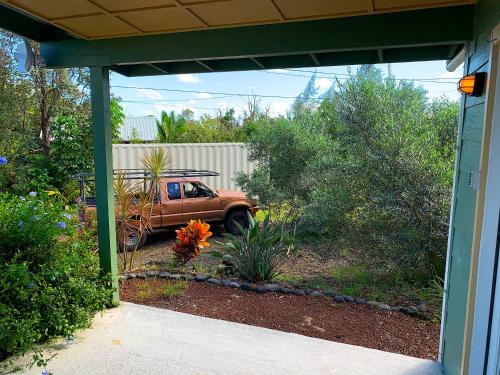 an outside view of a yard with a truck at Puna Pod in Pahoa