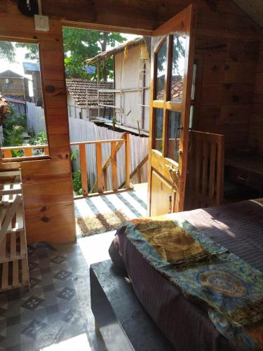 a bedroom with an open door to a house at Drishti yoga international in Patnem