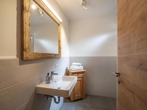 a bathroom with a sink and a mirror at Alpine Homes - Hopfgarten in Hopfgarten im Brixental