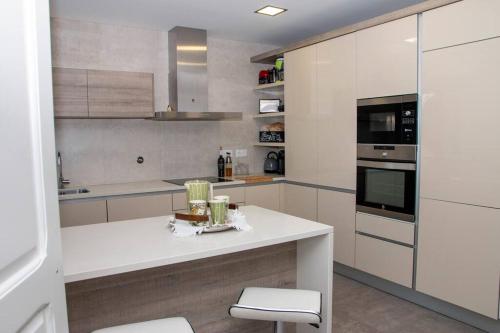 a kitchen with white cabinets and a white counter top at Beautiful cozy cottage near Nazaré, Leiria&Batalha in Juncal