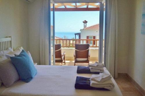 a bedroom with a bed with a view of the ocean at Belvedere, LaVanta, Kalkan in Kalkan