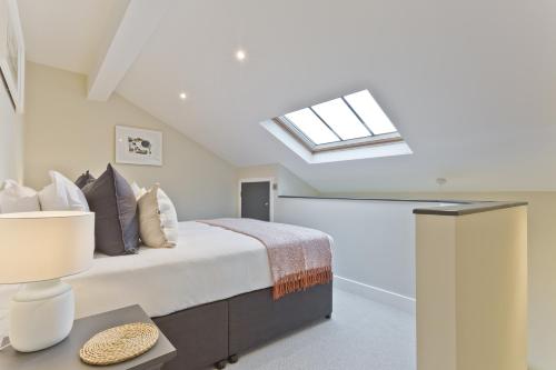 a bedroom with a bed and a skylight at Sandgate Chapel - Self Check In Apartments in Penrith
