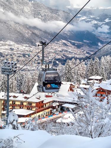 a ski lift in the snow on a mountain at Hotel Caminetto in Folgarida
