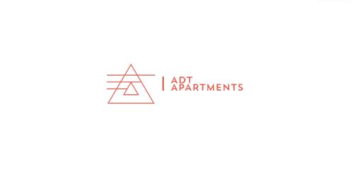 a logo with the words i art experiments at ADT apartments in Almaty
