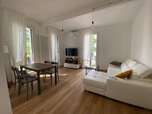 a living room with a white couch and a table at Ca' Luciano alloggio a Lido di Venezia in Venice-Lido