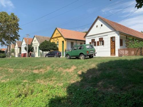 a green truck parked in front of a house at Feked Farmstay in Feked