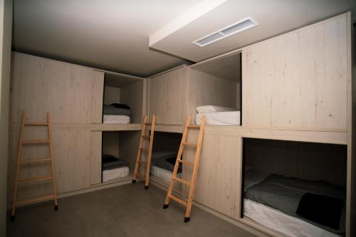 a room with two bunk beds and twoadders at Sierra Nevada Hostel in Sierra Nevada