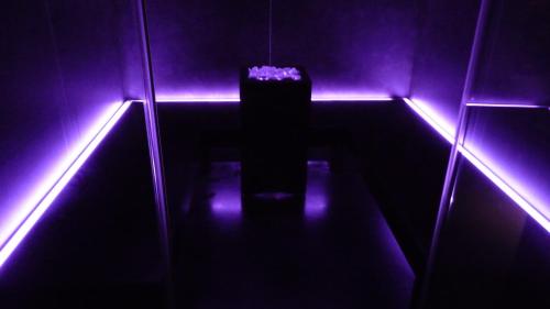 a dark room with purple lights on the floor at Hotel Milano & SPA***S in Verona