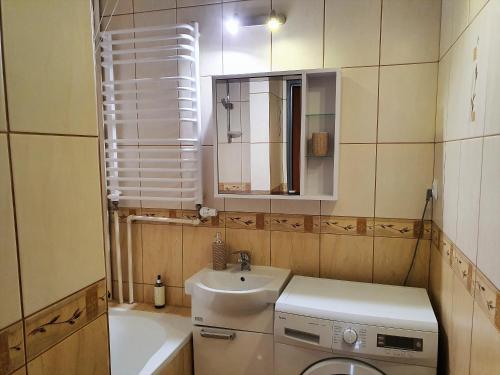 a small bathroom with a sink and a toilet at Happy Stay in Gliwice