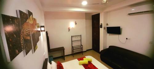 a living room with a black couch and a table at Weligama Watergate in Weligama