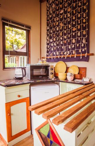 a kitchen with a counter top with a microwave at House of Art in Haenertsburg